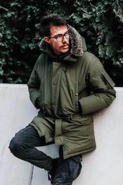 Young man in winter jacket posing outdoors Stock Photos