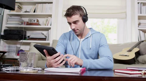 Young man with wireless digital tablet technology. Student house accommodation.  Vídeo Stock 32938695