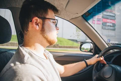 Young man without experience driving car Stock Photos