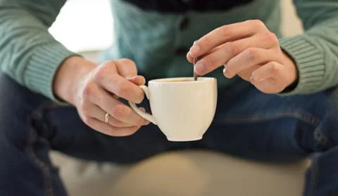 A Young Man without a Face Drinks Coffee Stock Photos
