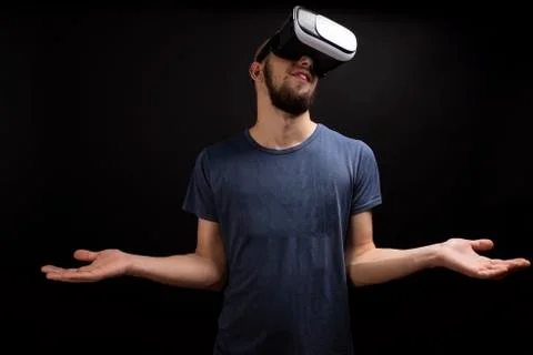 Young man wondering while using a VR gear Stock Photos