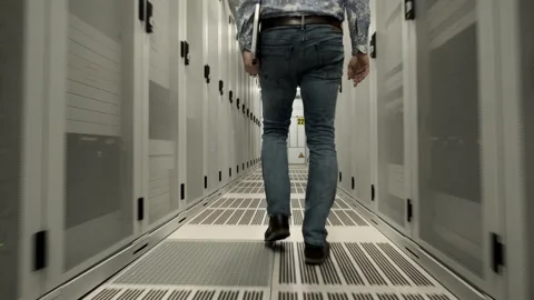 Young man at work inside a Dutch Datacenter corridor Stock Footage 294987961