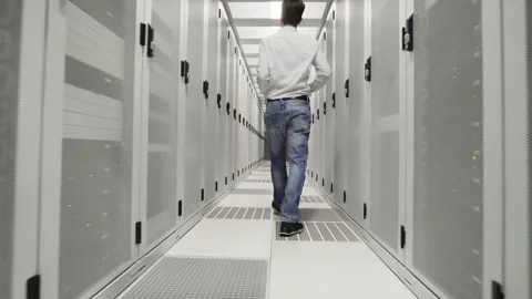 Young man at work inside a Dutch Datacenter corridor Stock Footage 294988006