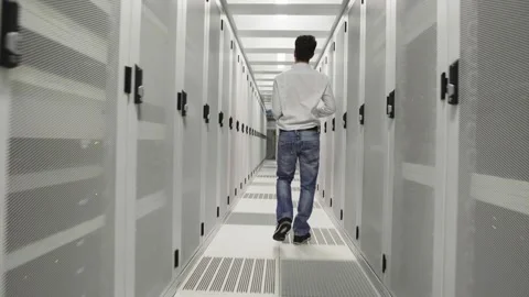 Young man at work inside a Dutch Datacenter corridor Stock Footage 294988019