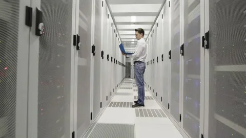 Young man at work inside a Dutch Datacenter corridor Stock Footage 294988037