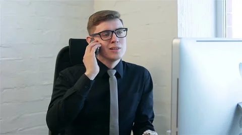 Young man at work in a office Stock Footage 51168001