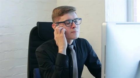 Young man at work in a office Stock Footage 51168939