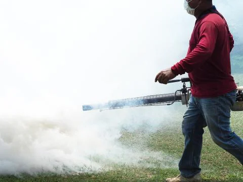 Young man worker are working fogging to eliminate mosquitoes Stock Photos