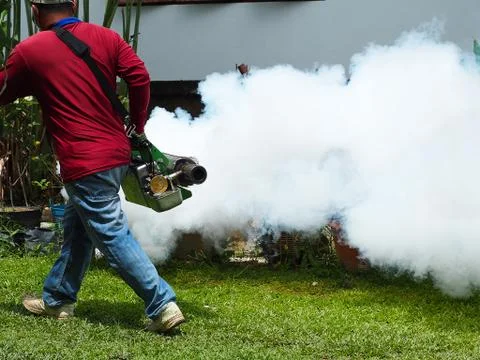 Young man worker are working fogging to eliminate mosquitoes Stock Photos