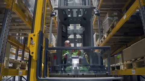 Young man worker moving on loading machine during working day in modern Stock Footage 127674730