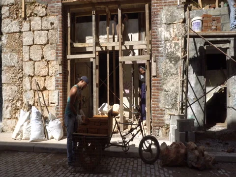 Young man worker is putting bricks on the construction Stock Footage 71057525