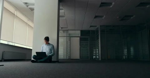 Young man working alone in empty office Stock Footage 58263960