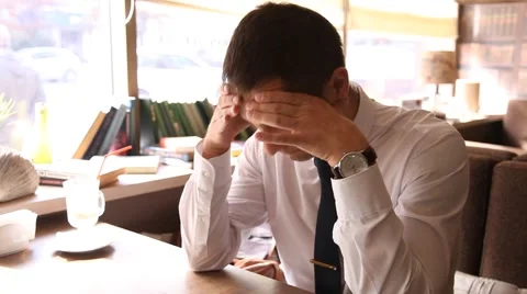 Young man working and bending his head in sadness Stock Footage 54691199