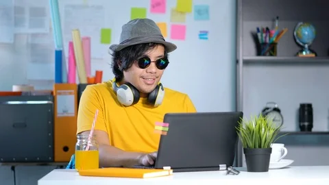 Young Man Working and Enjoying Music on Summer Vacation Season at Office.4k Stock Footage 91469947