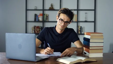 Young Man Working and Studying At Home, Using Laptop, Searching Internet Stock Footage 93281094