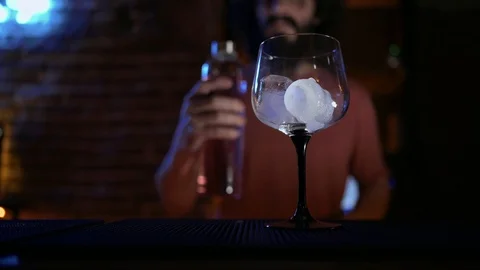 Young man, working in bar, pouring water into a glass Stock Footage 126909250