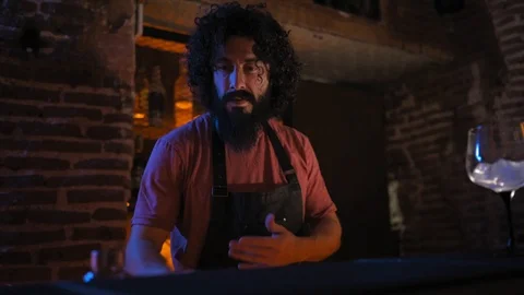 Young man, working in bar, pouring water into a glass Stock Footage 126909273