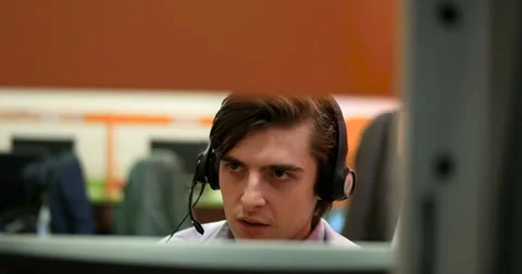 Young man working in a call center 스톡 동영상 67258245