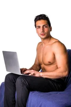Young man working with computer on couch Stock Photos
