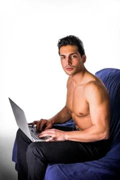 Young man working with computer on couch Stock Photos