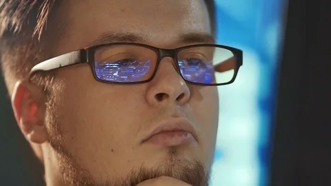 Young man working on computer in dark digital office Stock Footage 84514636