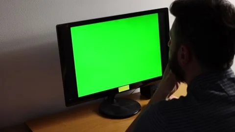 Young man working on computer with green screen Stock Footage 196224981