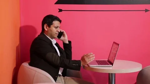 Young man is working on a computer - laptop computer showing charts and graphs.  Stock Footage 81470635