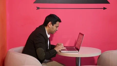 Young man is working on a computer - laptop computer showing charts and graphs.  Stock Footage 81470749