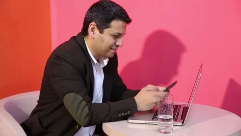 Young man is working on a computer - laptop computer showing charts and graphs.  Stock Footage 81470758