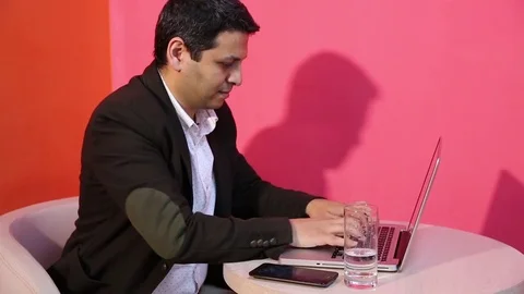 Young man is working on a computer - laptop computer showing charts and graphs.  Stock Footage 81470881