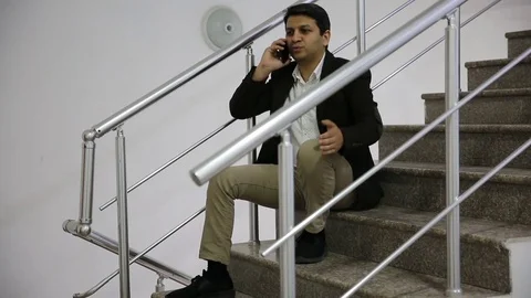 Young man is working on a computer - laptop computer showing charts and graphs.  Stock Footage 81471057