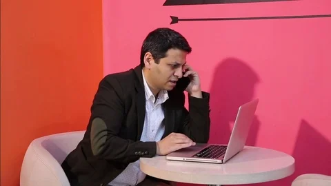 Young man is working on a computer - laptop computer showing charts and graphs.  Stock Footage 81471074