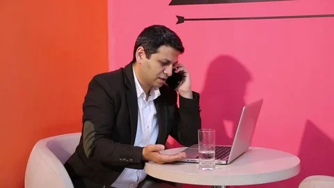 Young man is working on a computer - laptop computer showing charts and graphs.  Stock Footage 81471090