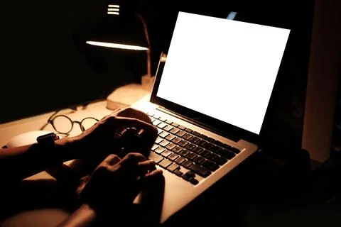 Young man working with computer laptop at night. Stock Photos