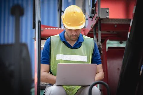 Young man working with computer at logistic import and export terminal indust Stock Photos