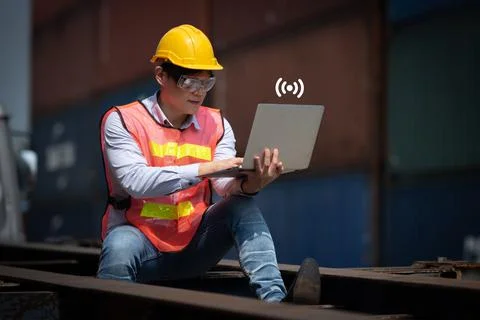Young man working with computer at logistic import and export terminal indust Stock Photos