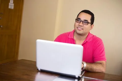 Young man working on a computer looking thoughtful Stock Photos