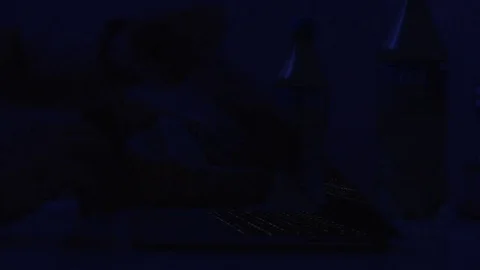 Young man working on computer at night in dark room. The designer works in the Stock Footage 85028985