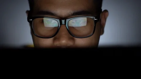 Young man working on computer at night Stock Footage 127553315