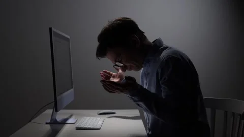 Young man working on computer at night showing frustration and stress Stock Footage 342671794