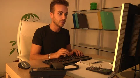 Young man working on computer in office. Stock Footage 31650724