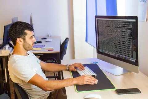 Young man working on computer in office Stock Photos