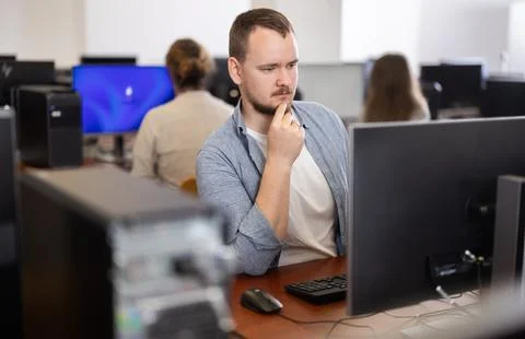 Young man working on computer in office Stock Photos