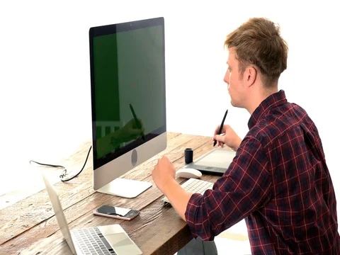 A young man working on a computer in their home. Video stock 82852880