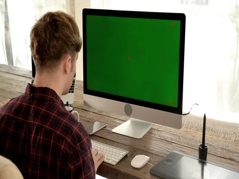 A young man working on a computer in their home. Video stock 82852881