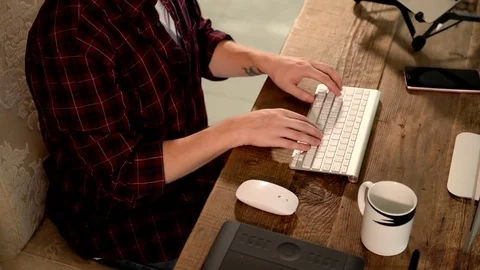 A young man working on a computer in their home. Stock Footage 82922703