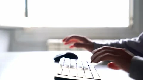 Young man working with computer typing on the keyboard and using the mouse. T Stock Footage 133232819