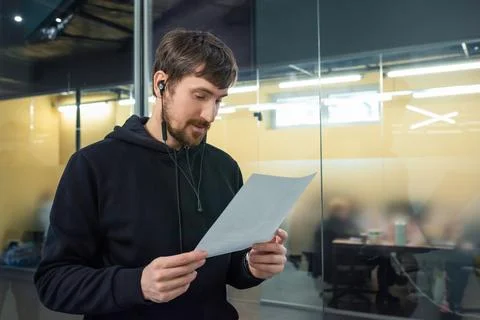 Young man working with documents in the office. Business, consultation, online Stock Photos