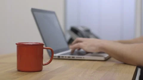 Young man working drinks cup of coffee Stock-Footage 68614794
