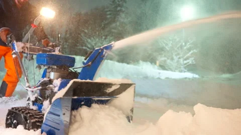 Young man working, efficient blower machinery, heavy snowfall Stock Footage 302780823